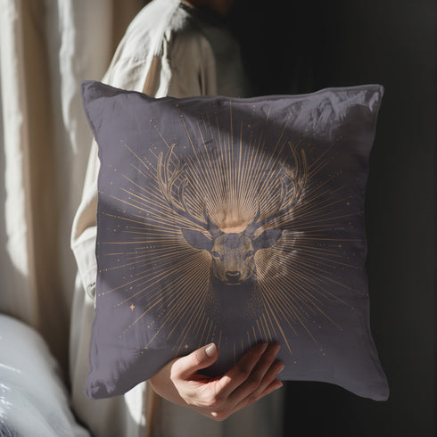 A pillow cover showing a noble stag rendered in shimmering beige against navy blue fabric. Fine beige tan rays extend from the deer's head like sunbeams, with scattered stars.
